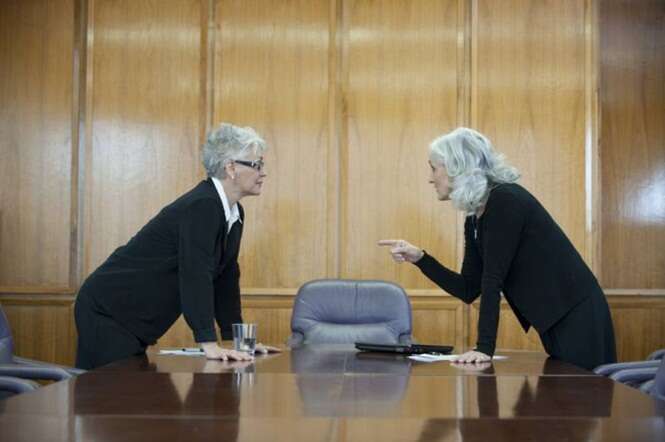 Caucasian businesswoman arguing in conference room