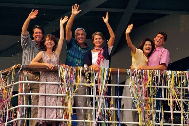 Couples waving from deck of cruise ship