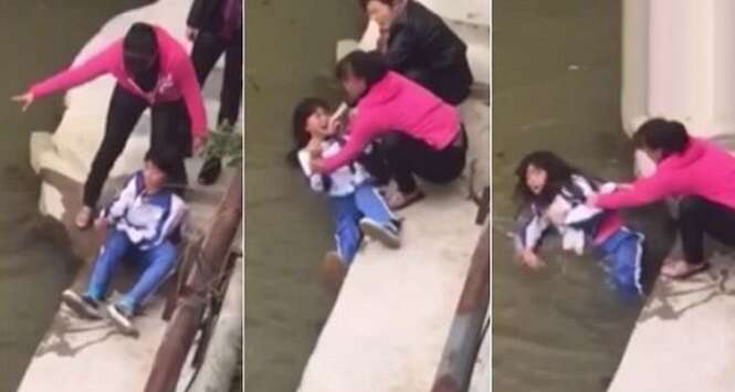Mãe é filmada prestes a afogar filha em rio como punição Mãe é filmada prestes a afogar filha em rio como punição