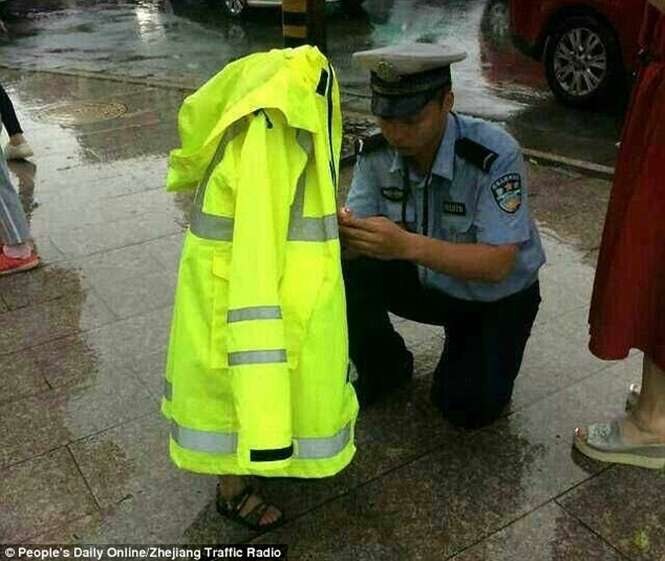 Policial cede casaco impermeável para menino perdido em dia chuvoso