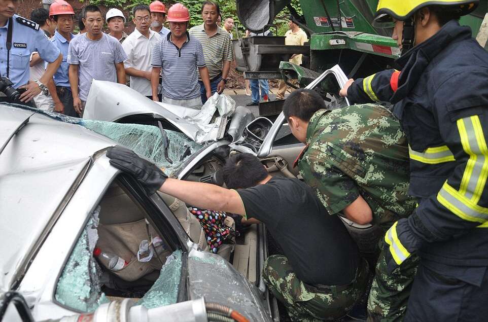 Woman Survives After Her Car is Flattened by a Cement Mixer, Hangzhou, Zhejiang Province, China - 18 Aug 2014