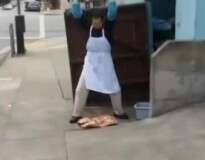 Funcionário de restaurante causa polêmica ao ser flagrado amaciando carne no chão de calçada