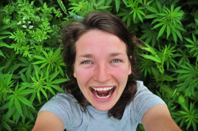 Selfie of young woman in marijuana field