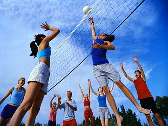 ca. 2002 --- Teenagers Playing Volleyball --- Image by © Roy Morsch/CORBIS